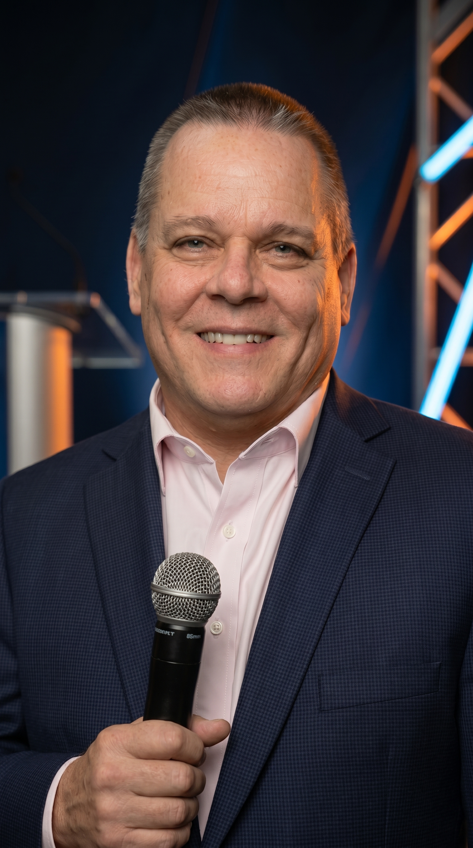Steve Wormer speaking on stage at a live event